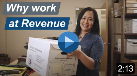 Video still with the title "Why work at Revenue." Smiling, dark-haired woman holding a box of files on a room with shelves and office supplies. Image links to a YouTube video which is 2 minutes and 13 seconds long.